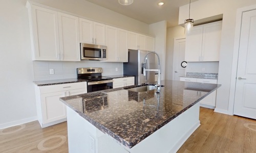 a kitchen with white cabinets